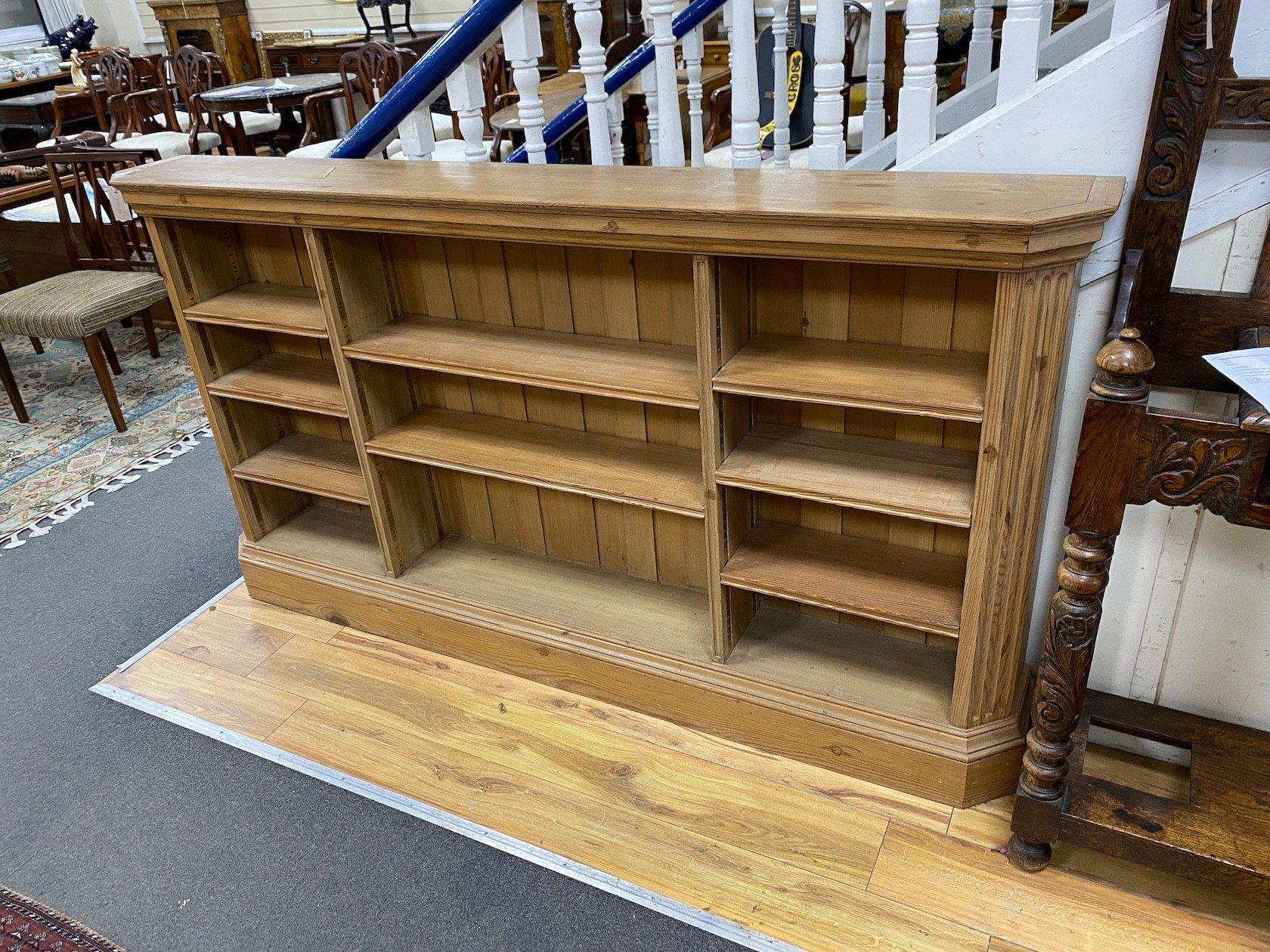 A Victorian style pine open bookcase, width 188cm, depth 25cm, height 102cm